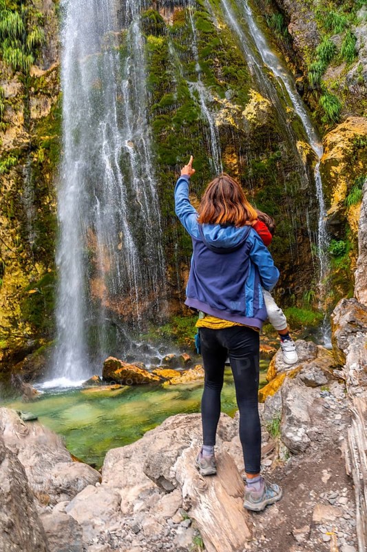 Mother with her son Grunas waterfall in Theth national park