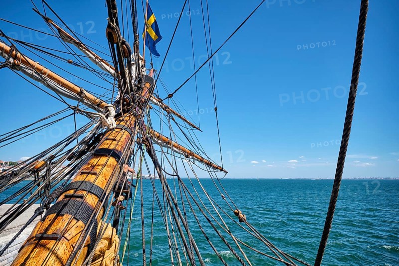 Bowspirit of old wooden sail ship with a lot of gear cordage rope