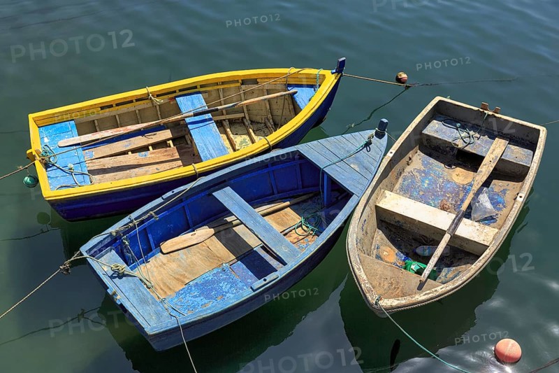Three rowing boats side by side in the harbour