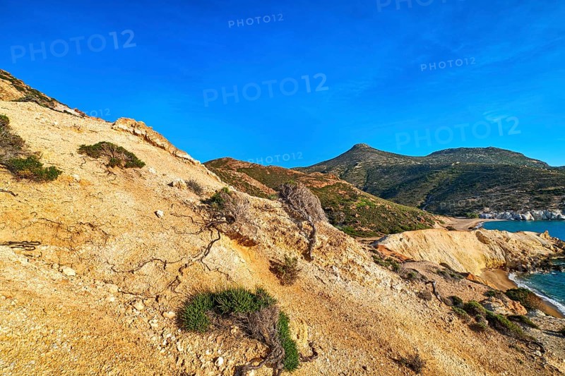 Unique natural rock formations of yellow and orange cliffs in low sunlight