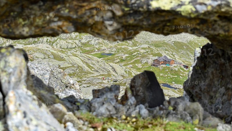 View through a rock window to the Magdeburger Huette in the Stubai Alps