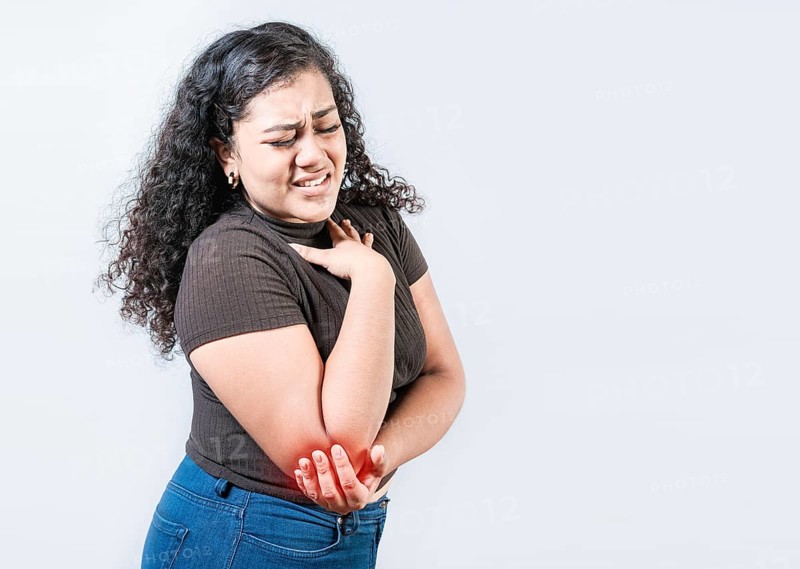 People with elbow pain isolated. Woman with elbow pain from rheumatism. Young girl suffering cramp elbow isolated
