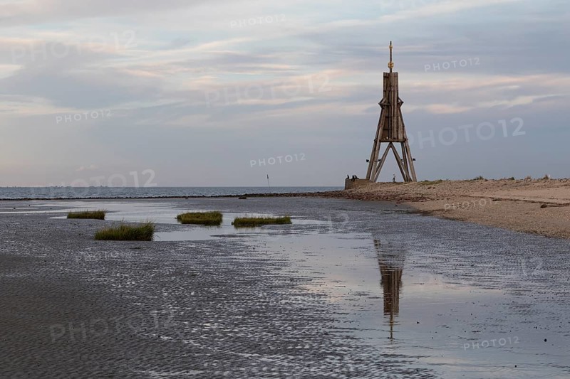 Kugelbake with water reflection in the mudflats at low tide at dusk
