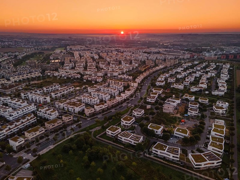 The sun rises behind the Riedberg district of Frankfurt.
