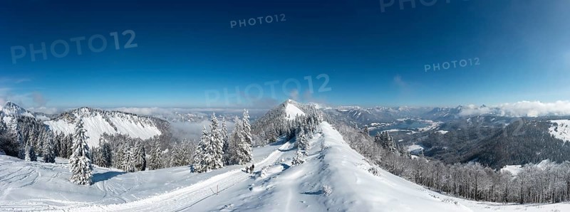 Winter landscape covered in deep snow in the Osterhorn group with a view from Pillstein to Zwoelferhorn and Wolfgangsee