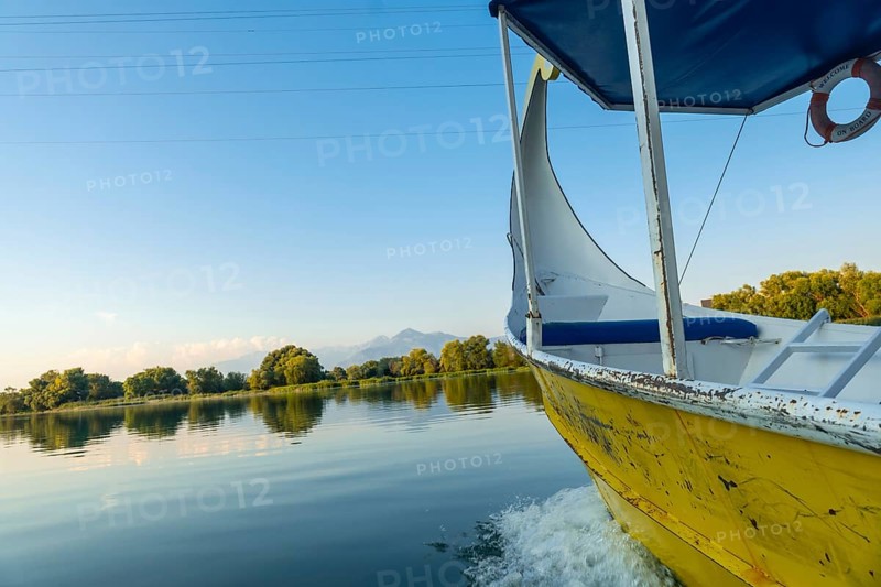 Sailing around the lake in a traditional boat on a sightseeing excursion from Shkoder in Shiroka. Albania