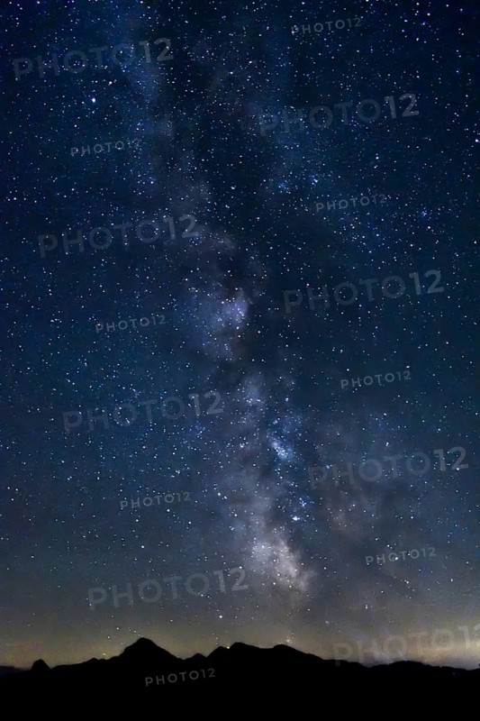 Starry sky with the Milky Way above the highest mountain of the Chiemgau Alps