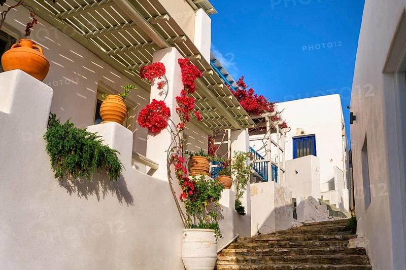 Traditional Greek island town alleyway with whitewashed walls