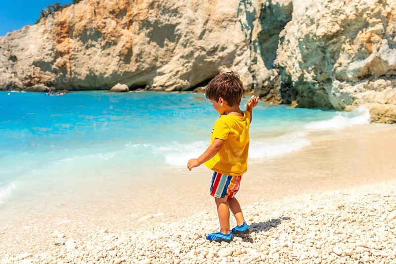Boy having fun on Porto Katsiki beach in summer vacation Lefkada island