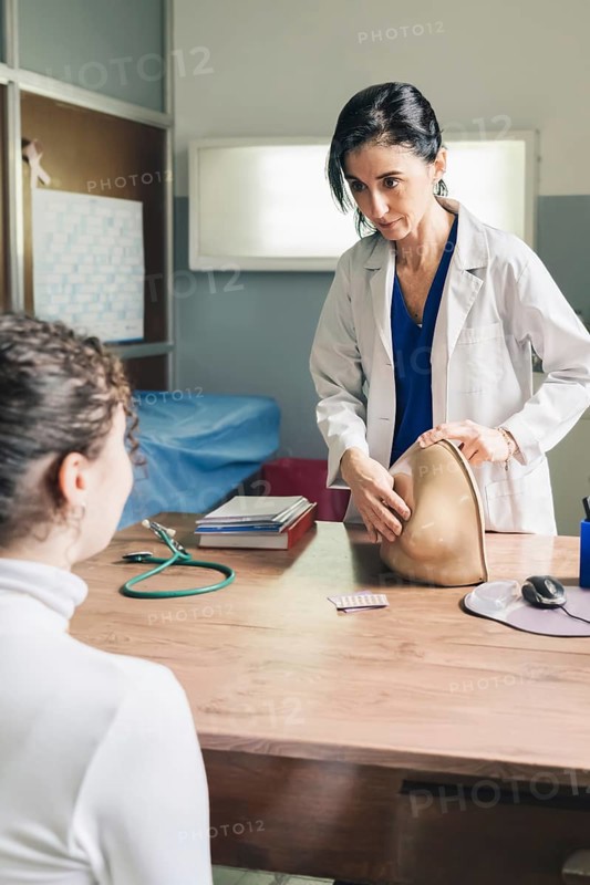 Gynecological doctor teaching breast self-examination. Fight against breast cancer