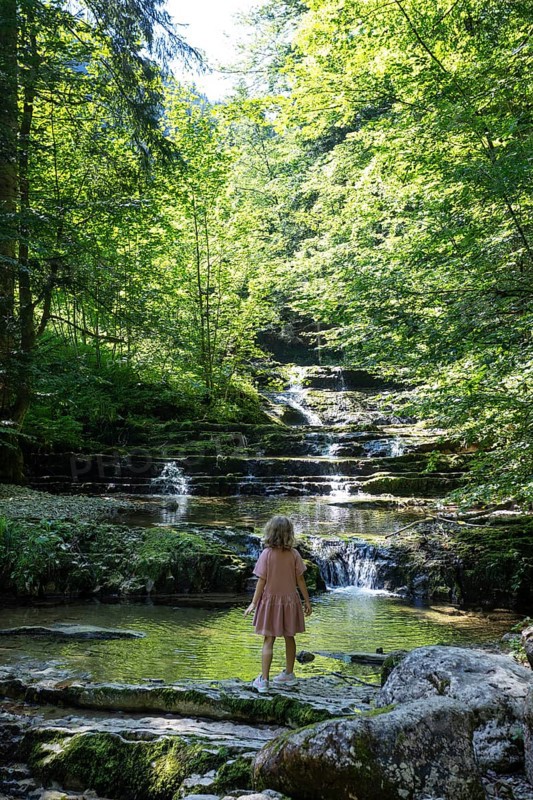 Girl on the bank of the Taugl at the Wald Wasser Zauber Weg near Hintersee