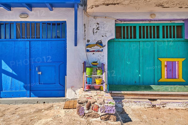 Colorful blue and green boat garage doors in Klima fishermen village