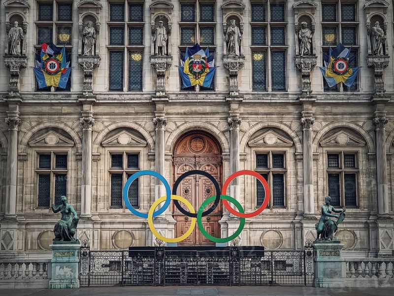Close up Paris City Hall entrance. Outdoors view to the beautiful ornate facade of the historical building and the olympic games rings symbol in front of the central doors