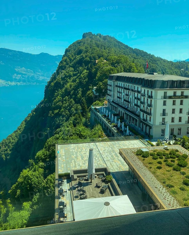 Panoramic Window View over Hotel Palace and Lake Lucerne and Mountain in a Sunny Summer Day in Burgenstock