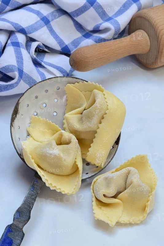 Freshly prepared tortelloni in a sieve ladle
