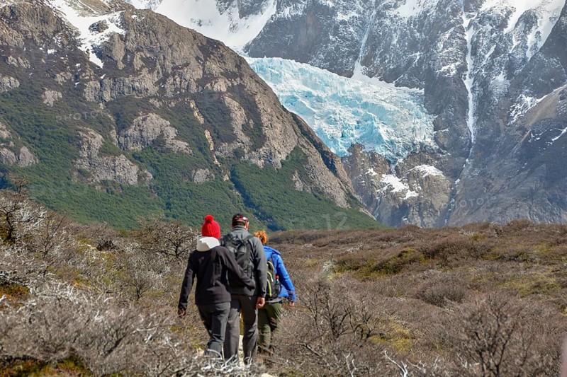 Hikers walking towards a glacier on the way to Laguna de los tres