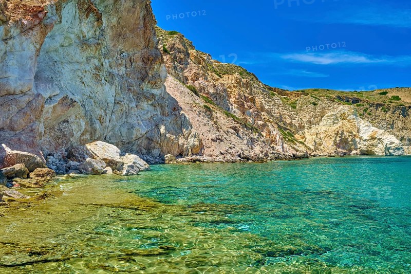 Beautiful view of high hill slope of island in Mediterranean Sea. Blue sea waters