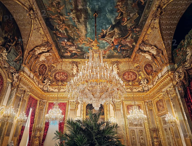 Beautiful decorated Napoleon apartments at Louvre palace. Royal family rooms with cardinal red curtains