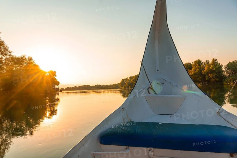Sunset sailing on the lake in a traditional boat on a sightseeing excursion from Shkoder in Shiroka. Albania