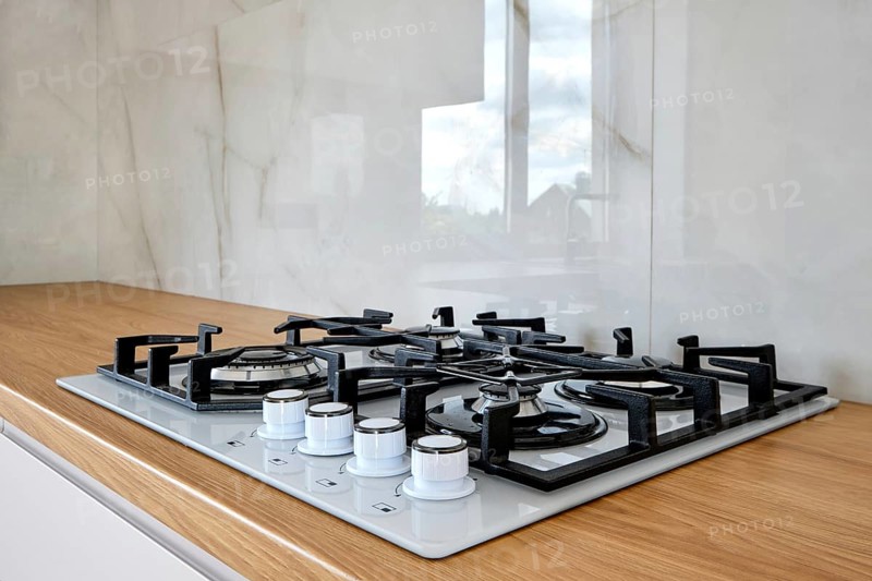 Modern built-in gass stove on wooden countertop
