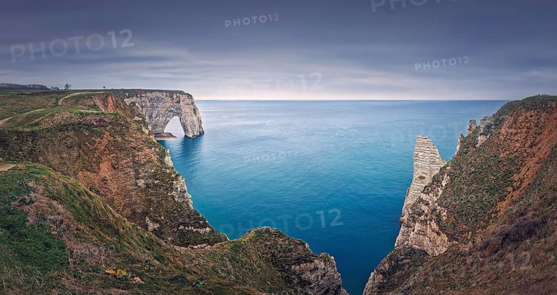 Beautiful panorama of the Porte d'Aval natural arch at Etretat famous cliffs