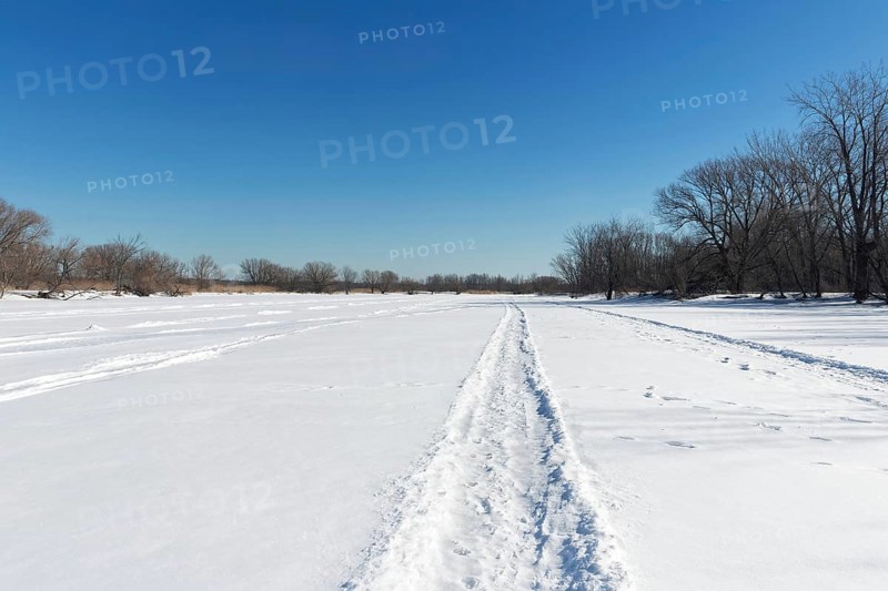 Vehicle tracks on snow covered frozen river