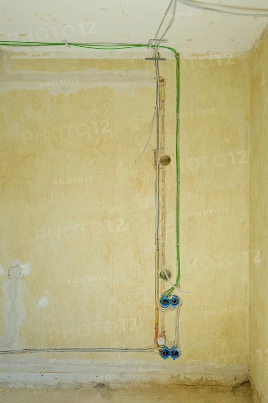 Power and network cables on a wall