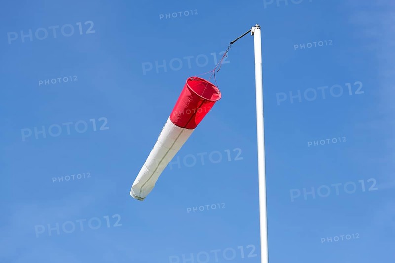 White-red windsock against blue sky