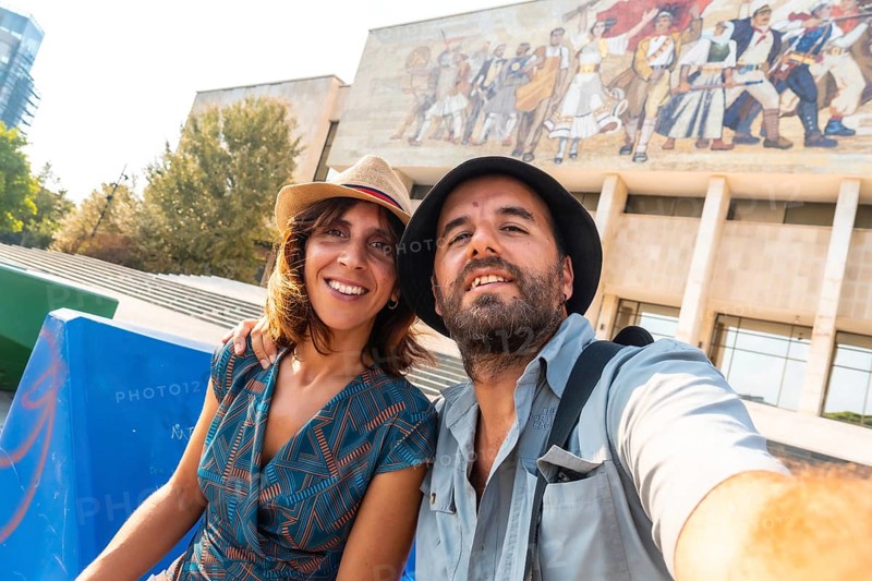 Selfie of a tourist couple visiting the National Historical Museum in Skanderbeg Square in Tirana. Albania