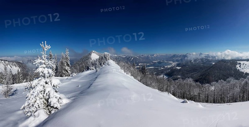 Winter landscape covered in deep snow in the Osterhorn group with a view from Pillstein to Zwoelferhorn
