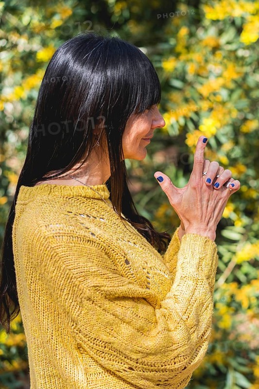 Side view of Kali mudra executed by a woman over nature background