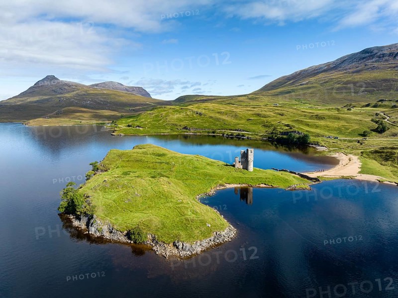 Aerial view of the freshwater loch Loch Assynt with the ruins of Ardvreck Castle on a peninsula