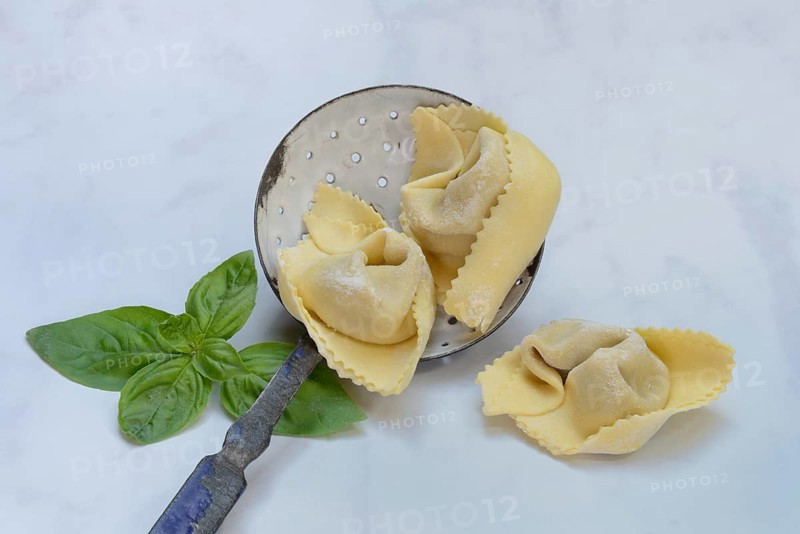 Freshly prepared tortelloni in a sieve ladle