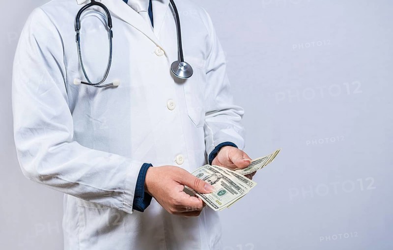 Medical corruption concept. Corrupt doctor counting money isolated