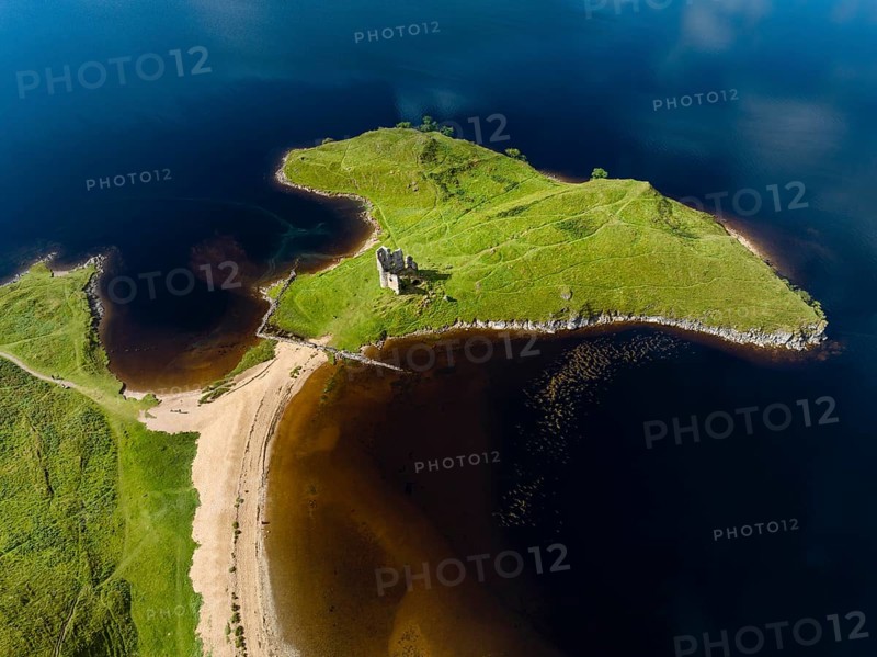 Aerial view of the freshwater loch Loch Assynt with the ruins of Ardvreck Castle on a peninsula