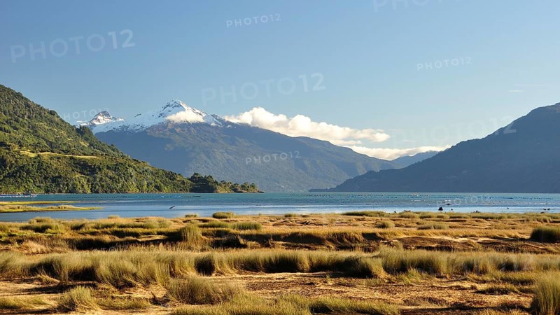 The Estero Reloncavi near Cochamo in southern Chile with the snow-capped volcano Yate