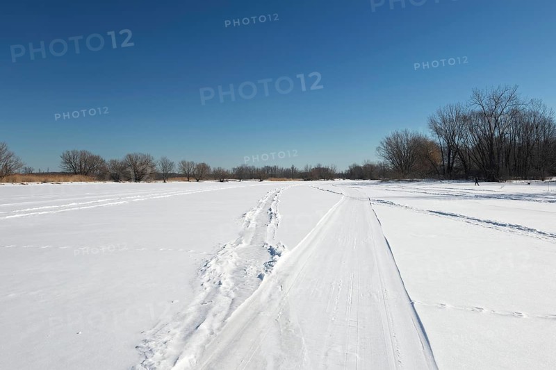 Vehicle tracks on snow covered frozen river