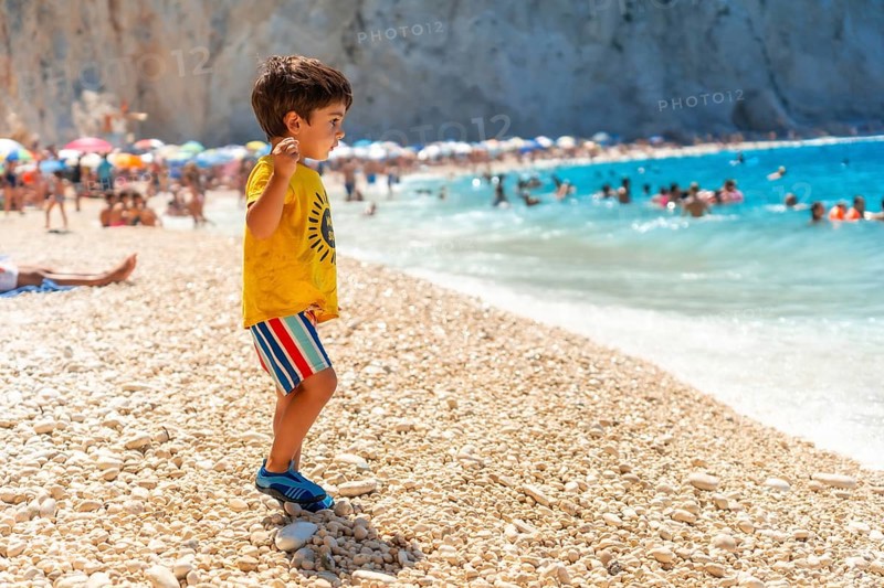 Boy having fun on Porto Katsiki beach in Lefkada island on vacation