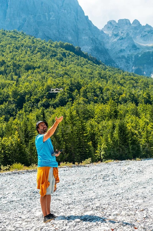 Drone pilot man taking off exploring new places in the mountain. Use of drone photography