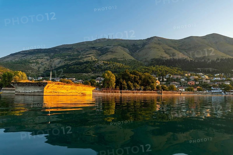 View of the city of Shiroka from the lake on a traditional boat on a sightseeing excursion from Shkoder. Albania