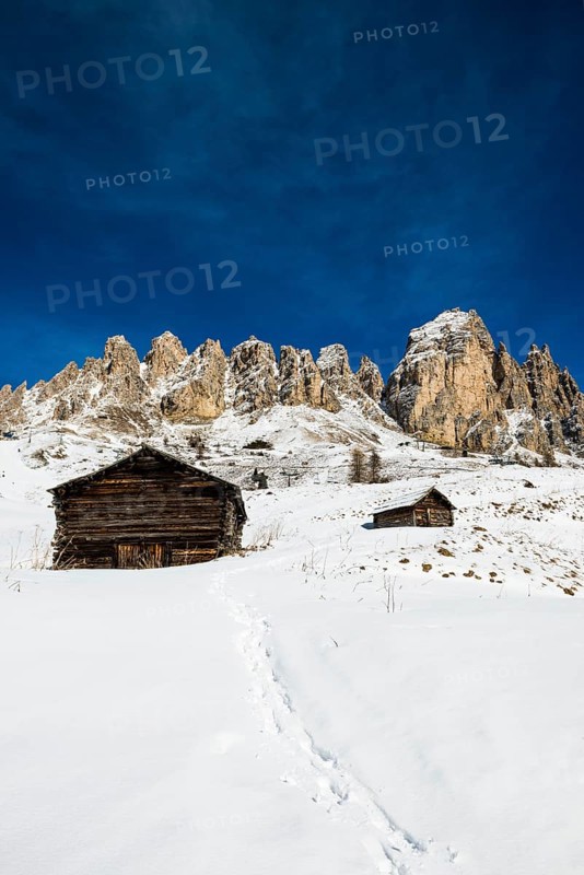 Snow-covered mountains and alpine hut