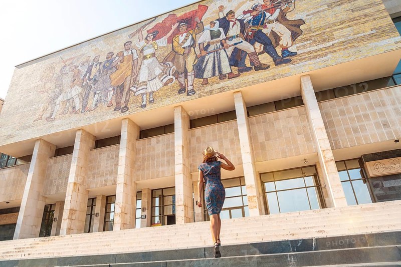 A female tourist walking up the stairs to the National Historical Museum in Skanderbeg Square in Tirana. Albania