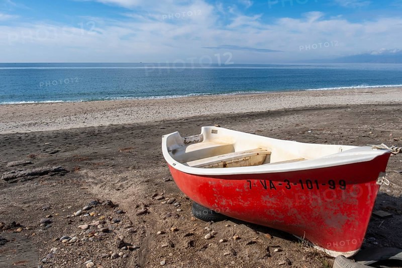 Red boat on Las Salinas de Cabo de Gata beach