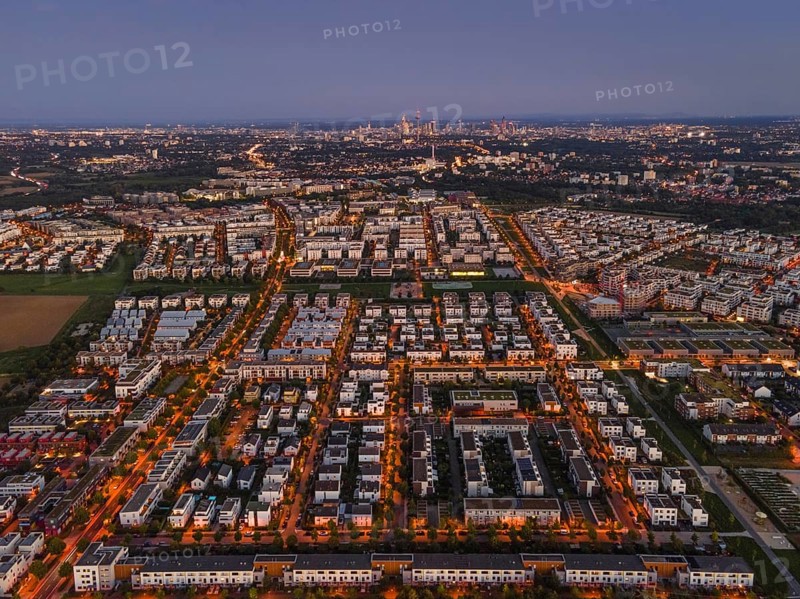 The lights of the buildings and street lamps in Frankfurt's Riedberg district shine in the evening