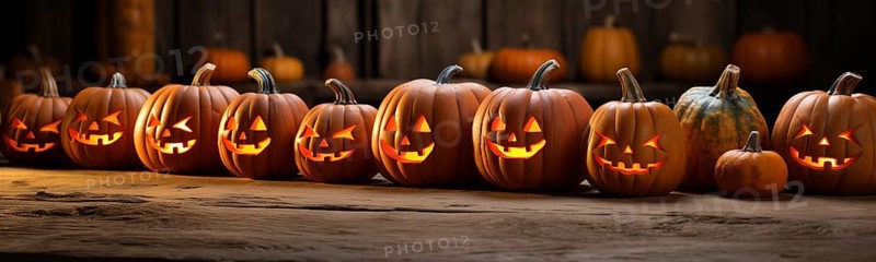 Spooky and fun collection of dozens of halloween carved pumpkins outside on hallows eve