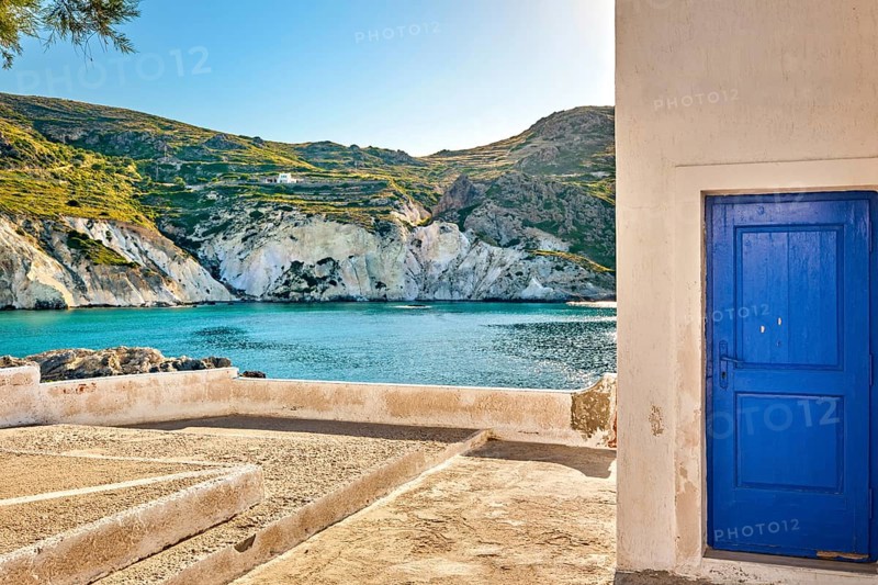Sunny summer landscape on Greek island. Traditional whitewashed terrace