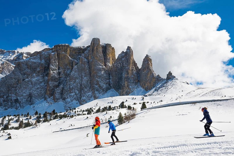 Snow-covered mountains and skiers
