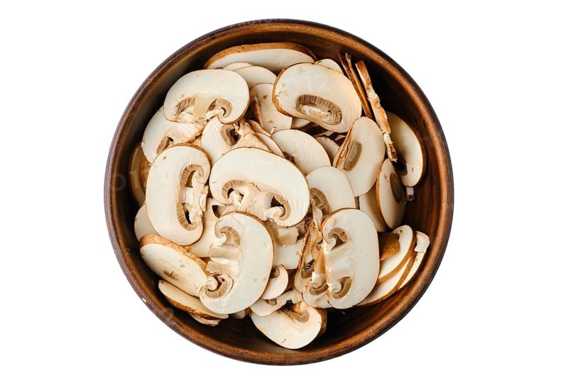 Top view of bowl with sliced brown cap champignons isolated on white background