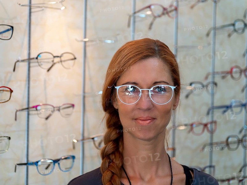 Woman at optician tries on new glasses