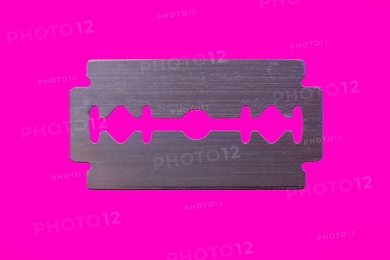 Razor blade against magenta background